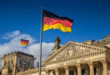 Germany Hits Record Political Crime High German flags at the Reichstag building in Berlin.