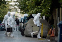 False Alarm Shuts Down Pentagon Areas Investigators in hazmat suits carrying equipment cases.