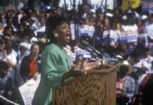 The ‘First Black President’ Debate Returns A woman passionately speaking at a political rally in front of a large crowd