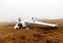 Crashed airplane lying on its side in a foggy field