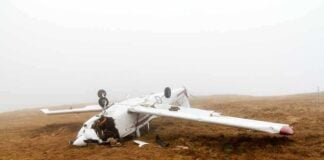11 Dead After Skydiving Plane Falls From the Sky Crashed airplane lying on its side in a foggy field