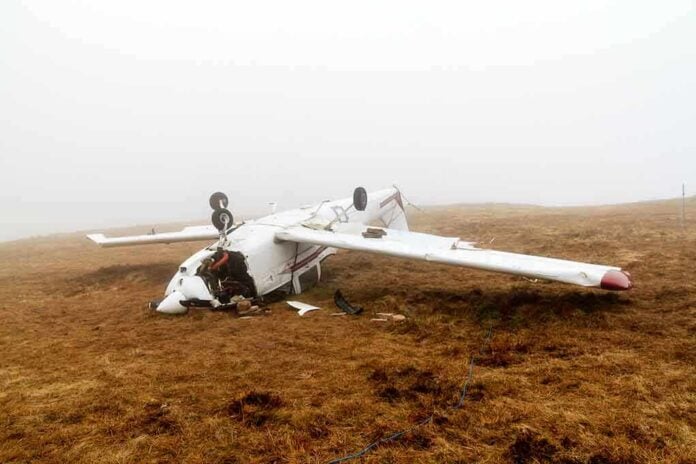 shutterstock_128891288 Crashed airplane lying on its side in a foggy field