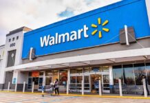 Exterior view of a Walmart store with customers entering and exiting