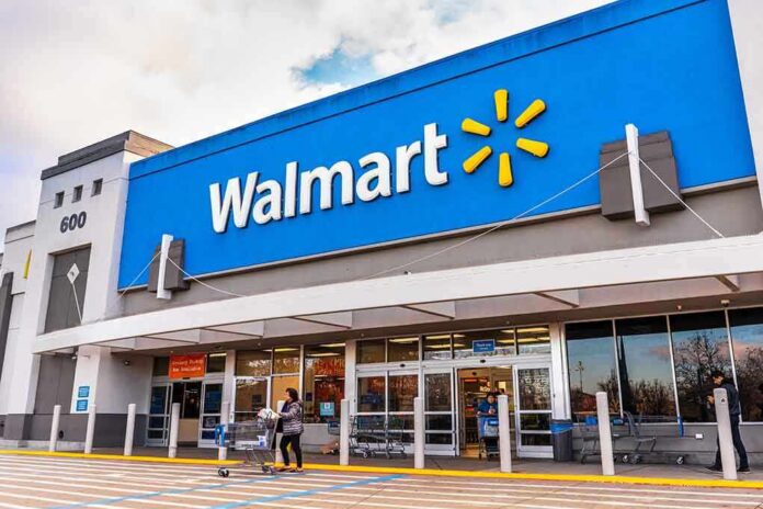 shutterstock_1643463436-1 Exterior view of a Walmart store with customers entering and exiting