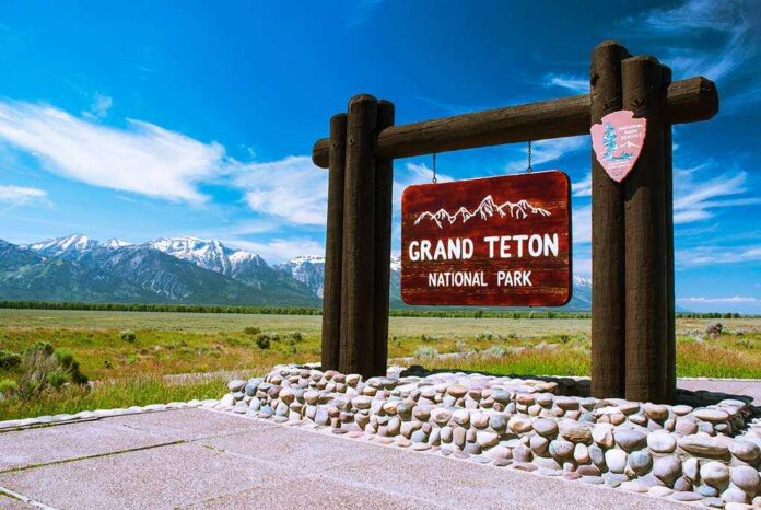 Entry,To,The,Grand,Teton,National,Park,,Wyoming Entrance sign for Grand Teton National Park with mountains in the background