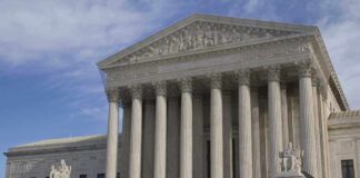 Virginia Gun Ban Faces Open Defiance The Supreme Court building featuring large columns and statues