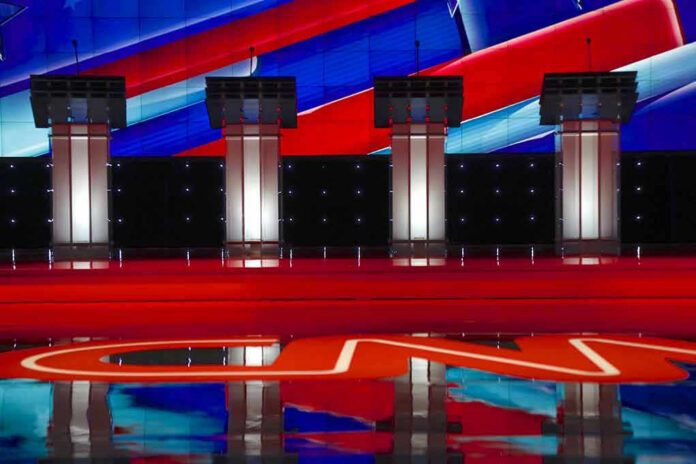353120126 Four debate podiums on a CNN stage background.