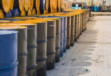 Oil Shock Warning: Hormuz Standoff Escalates Rows of oil barrels in a storage facility