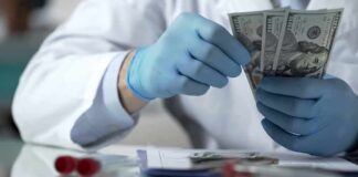 Gloved hands in a lab coat counting US dollar bills