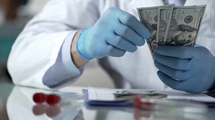 shutterstock_1086766712 Gloved hands in a lab coat counting US dollar bills