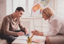 Two adults engaged in an art therapy session