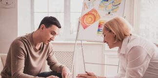 Two adults engaged in an art therapy session