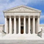 Supreme Court Unleashed Big Money in American Elections Front view of the Supreme Court building with large columns and steps under a blue sky