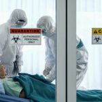 Ebola Deadly Outbreak, Unproven Vaccine Rollout Healthcare workers in hazmat suits treat a patient in a quarantine room