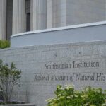 America’s Biggest History Museum Faces a Political Reckoning Smithsonian Institution museum exterior with engraved stone sign