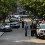 A Double Stabbing, a Viral Clip, and Growing Questions About Public Trust Police officers secure a residential street with patrol cars and yellow tape
