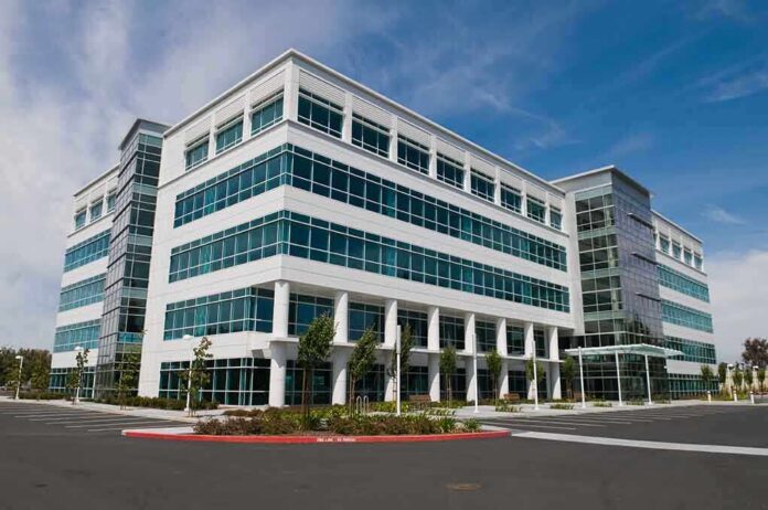 Modern office building with a glass facade and landscaped surroundings