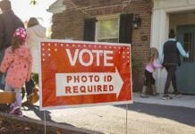 California Just Shut Down a Local Voter ID Law Red voting sign with arrow near people entering a polling place