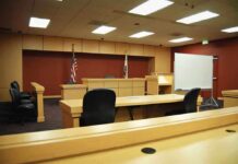 Tough Questions About Contracts and Pregnancy Rights Interior view of an empty courtroom with wooden furniture and American flags