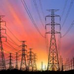 Power transmission towers and lines at sunset