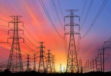 Power transmission towers and lines at sunset