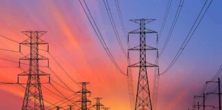 Power transmission towers and lines at sunset