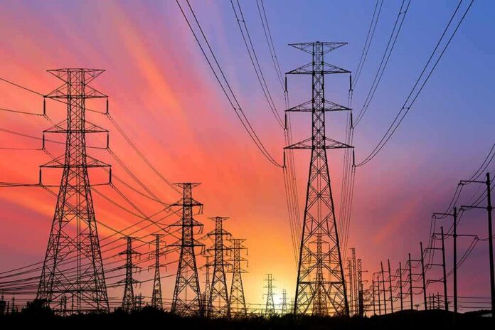 Power transmission towers and lines at sunset