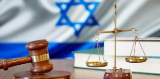 Gavel and scales of justice with Israeli flag in background