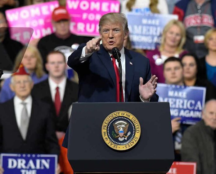 politician speaking at a rally podium
