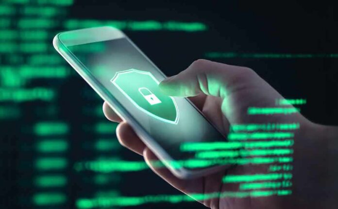 Hand holding smartphone with security lock icon on screen