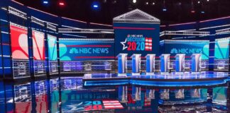 The Circumcision Question That Set Off A National Debate Televised debate stage with multiple podiums and bright red, white, and blue lighting