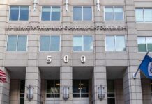 US government building facade with flags and number 500