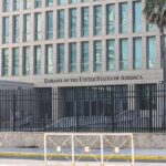 Visa Whiplash Begins — Families On Edge Embassy building behind tall black security fence