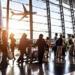 Marine’s Warning Before Abbey Gate Blast Raises Questions Passengers queue inside an airport terminal at sunset