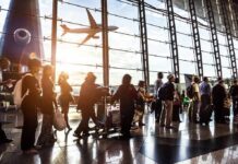 Marine’s Warning Before Abbey Gate Blast Raises Questions Passengers queue inside an airport terminal at sunset