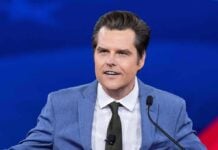 Streamer’s Defense Ignites New Firestorm Man in blue suit speaking at a podium