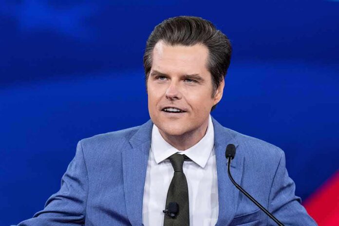 shutterstock_2187507895 Man in blue suit speaking at a podium