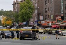 Police investigate a taped-off urban street crime scene