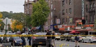Police investigate a taped-off urban street crime scene
