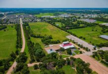 Aerial view of rural landscape with roads, fields, and scattered buildings