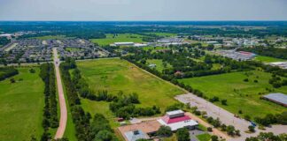 Aerial view of rural landscape with roads, fields, and scattered buildings