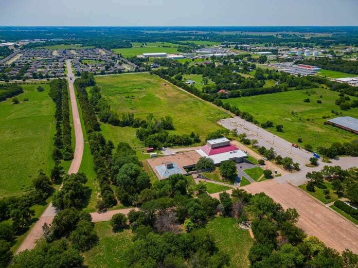 Aerial view of rural landscape with roads, fields, and scattered buildings