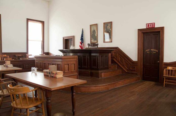 Tombstone,,Arizona,Courthouse,Courtroom Interior of a historic courtroom with wooden furniture and an American flag
