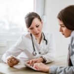 Late-Stage Drug Trials Offer New Hope for PTSD Doctor consulting a patient at a desk