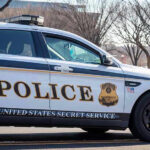 Wild SHOOTOUT Erupts — Felon TARGETS Secret Service! United States Secret Service police car on roadside.