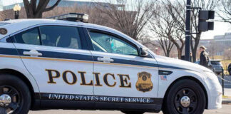 United States Secret Service police car on roadside.