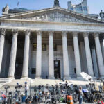 Drug Decriminalization Debate Explodes Reporters and photographers gathered outside a neoclassical courthouse