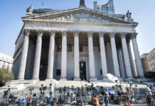 Courtroom Brawl Erupts: Surveillance Timeline Under Debate Teddy Williams at courthouse steps with media outside a neoclassical building