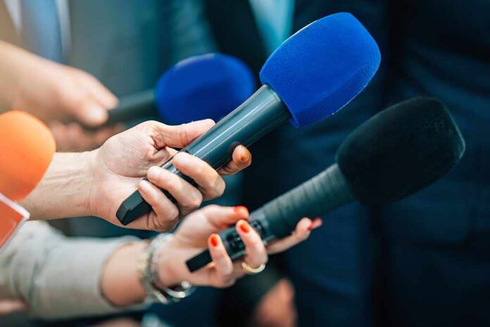 Media,Interview,Microphones,After,A,Press,Conference. Reporters holding colorful microphones