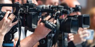 Flock Cameras Removed as Cities Turn to Rival License Plate Readers television cameras on tripods at a media event
